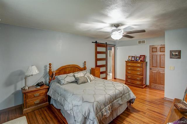 9514 State Route 143 Edwardsville, IL 62025 - Photo 10 of 29 a bedroom with bed and wooden floor