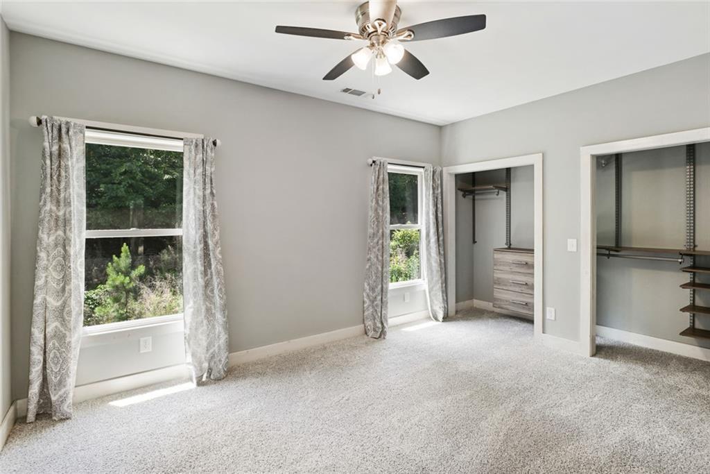 2040 Ridge Road Cumming, GA 30041 - Photo 21 of 52 a view of a big room with windows and chandelier fan