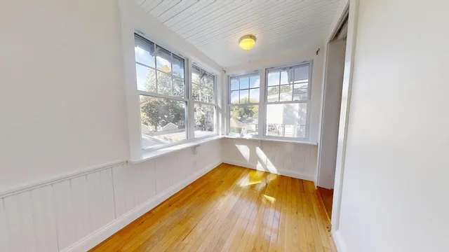 a view of a bathtub in a room with a window