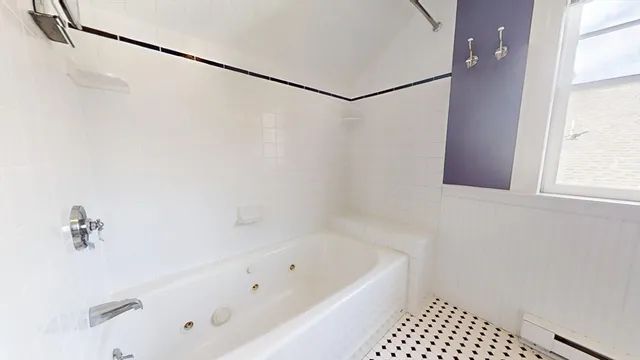 a bathroom with a bathtub and shower