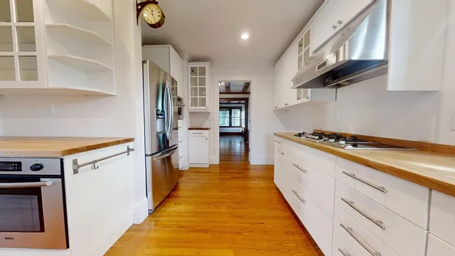 a kitchen with stainless steel appliances a stove and a refrigerator