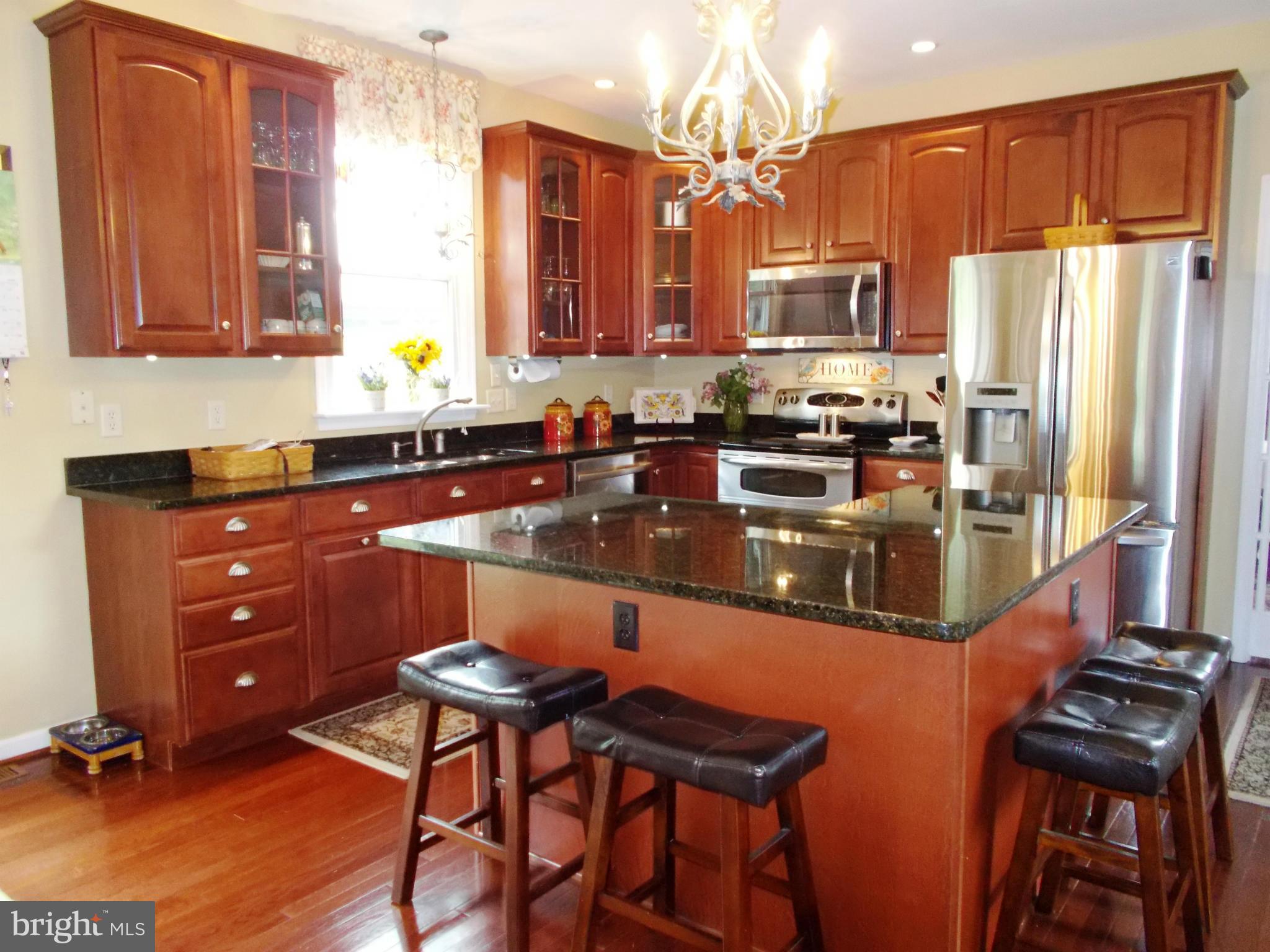 12658 Spickler Road Clear Spring, MD 21722 - Photo 12 of 21 a kitchen with stainless steel appliances granite countertop a sink stove and refrigerator