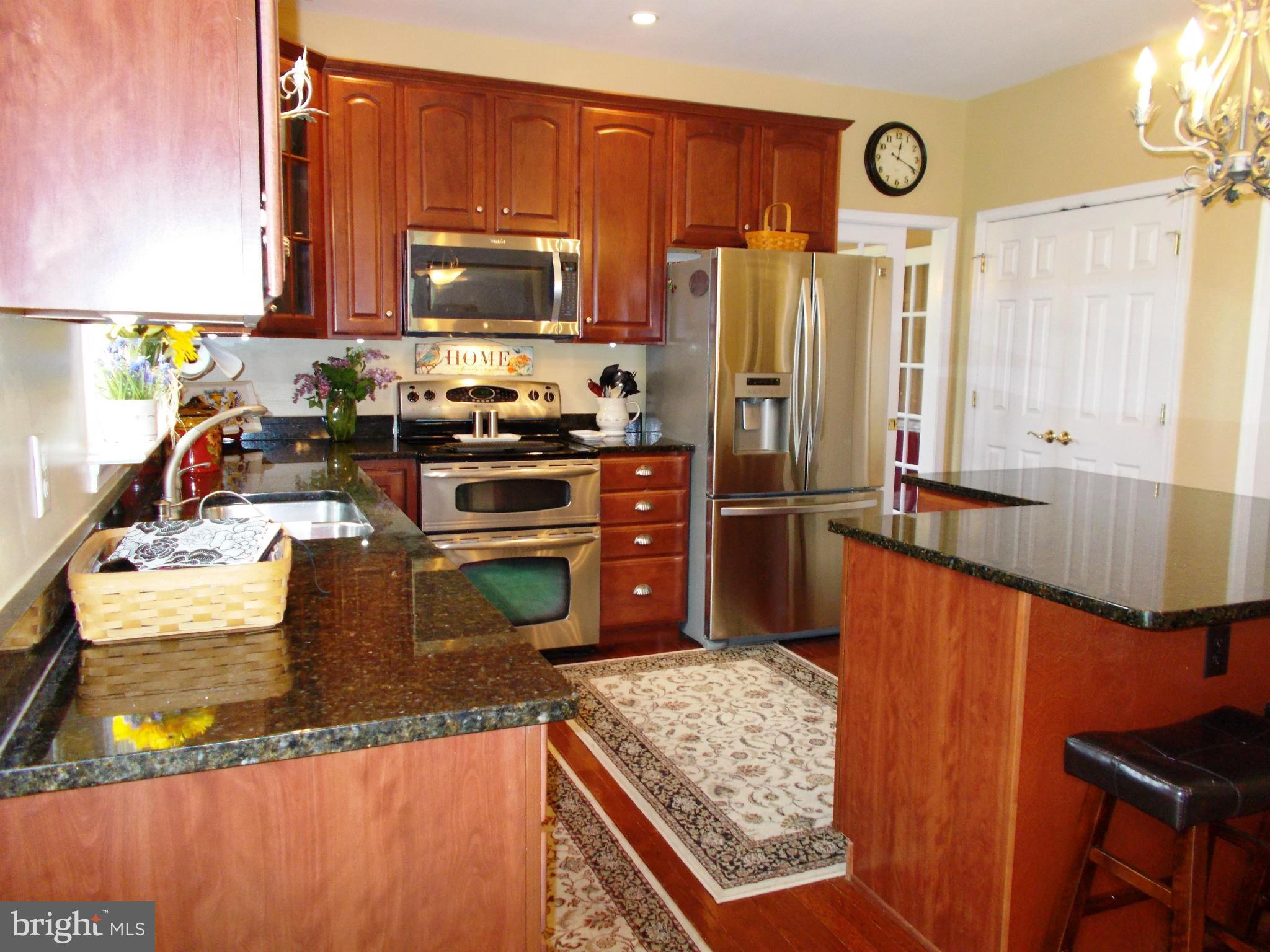 12658 Spickler Road Clear Spring, MD 21722 - Photo 13 of 21 a kitchen with stainless steel appliances granite countertop a sink stove and refrigerator