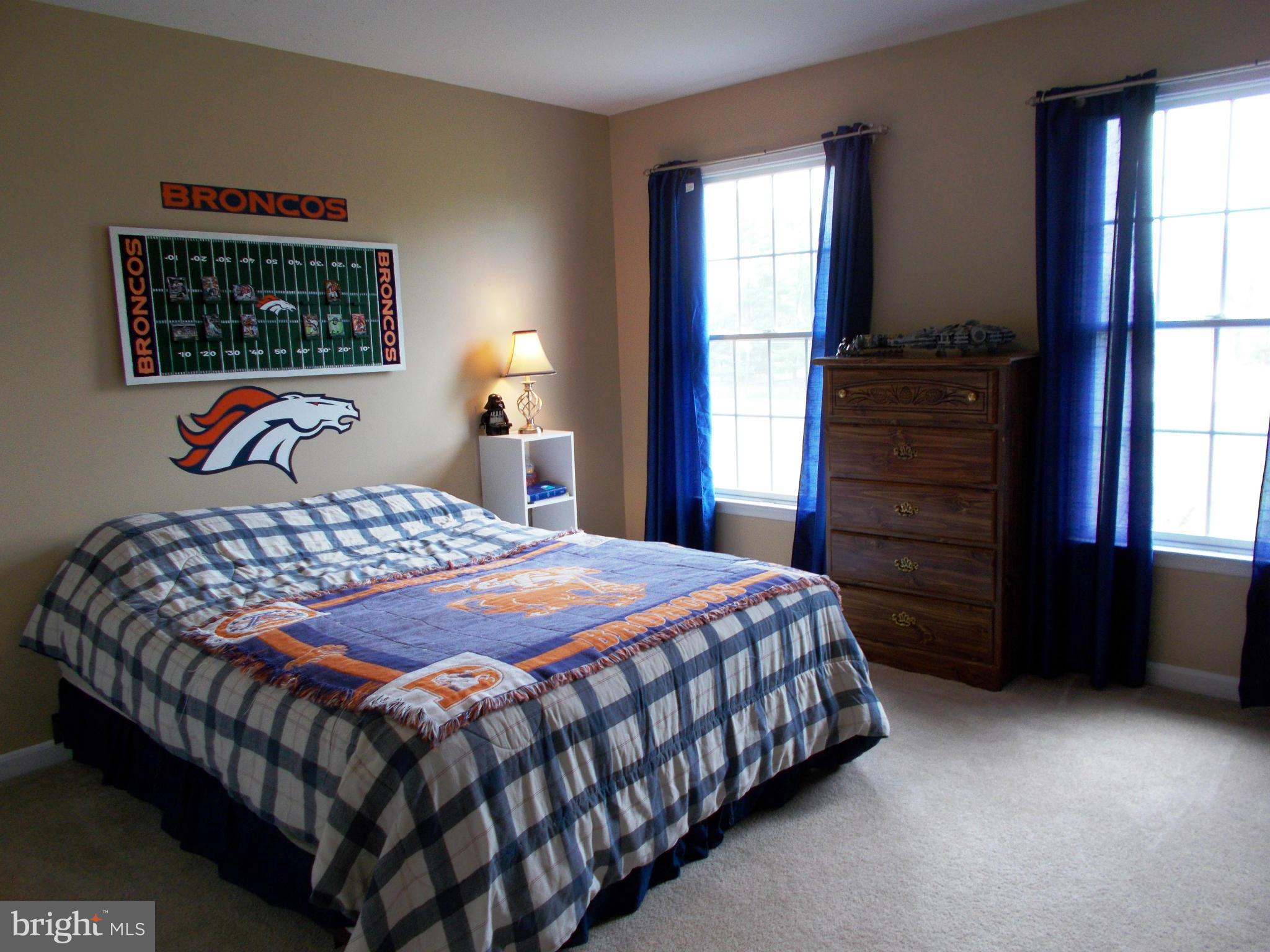 12658 Spickler Road Clear Spring, MD 21722 - Photo 19 of 21 a bedroom with a bed a dresser next to a window