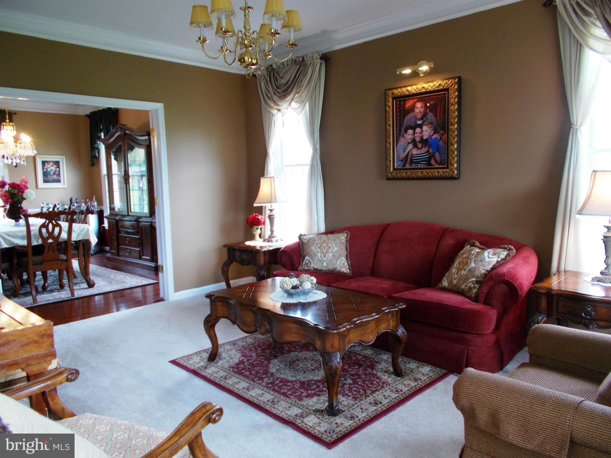 12658 Spickler Road Clear Spring, MD 21722 - Photo 7 of 21 a living room with furniture a dining table and a chandelier