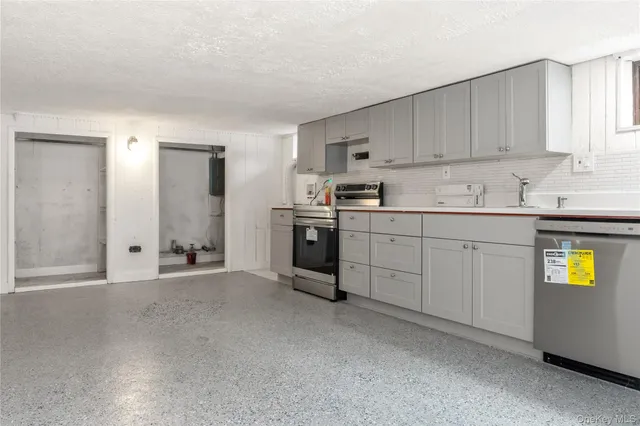 a kitchen with stainless steel appliances granite countertop a sink and cabinets