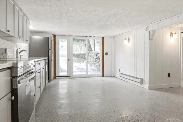 a view of a kitchen with electric appliances