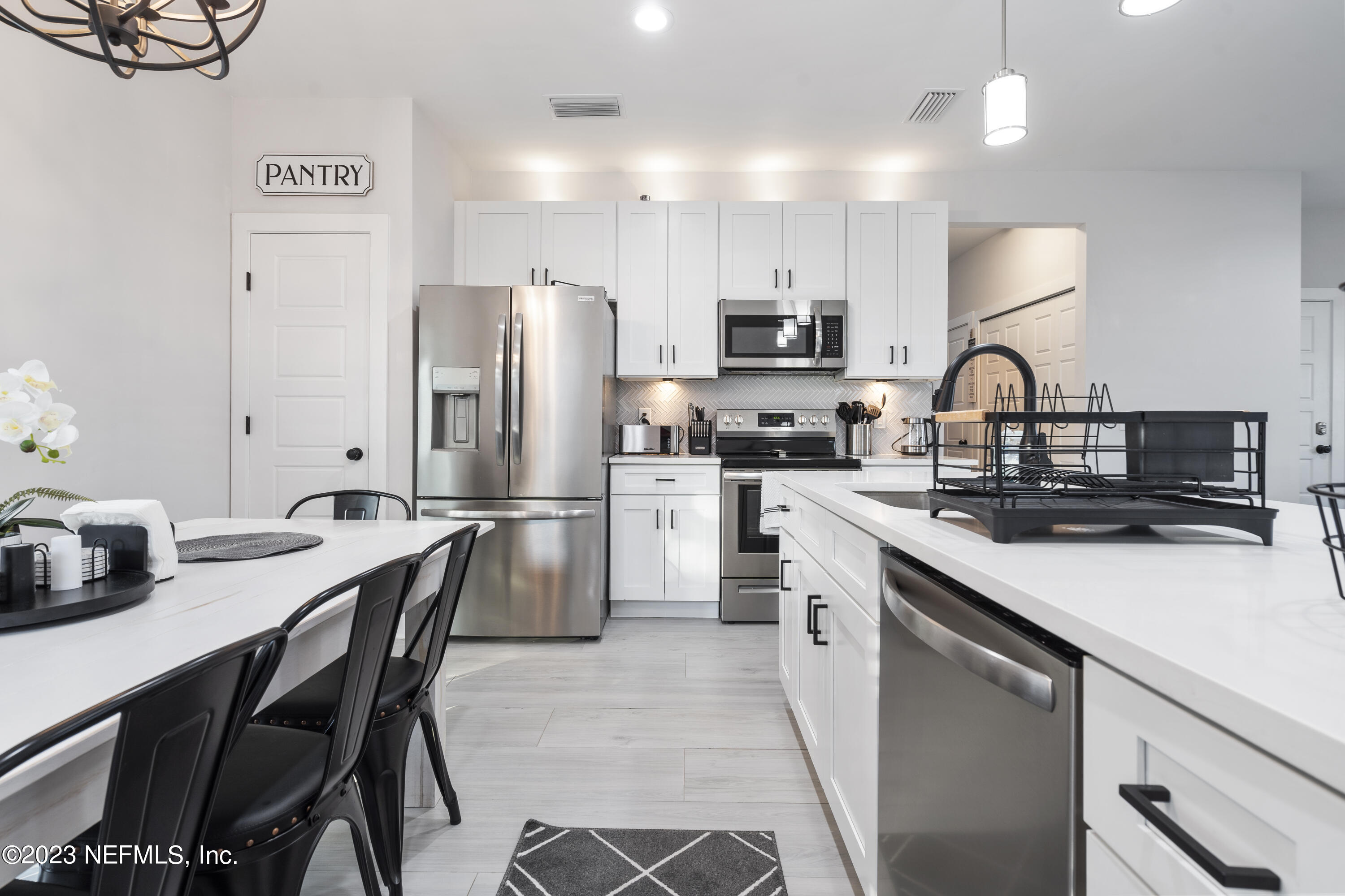 310 3rd Street St. Augustine, FL 32084 - Photo 13 of 46 a kitchen with a sink cabinets and stainless steel appliances