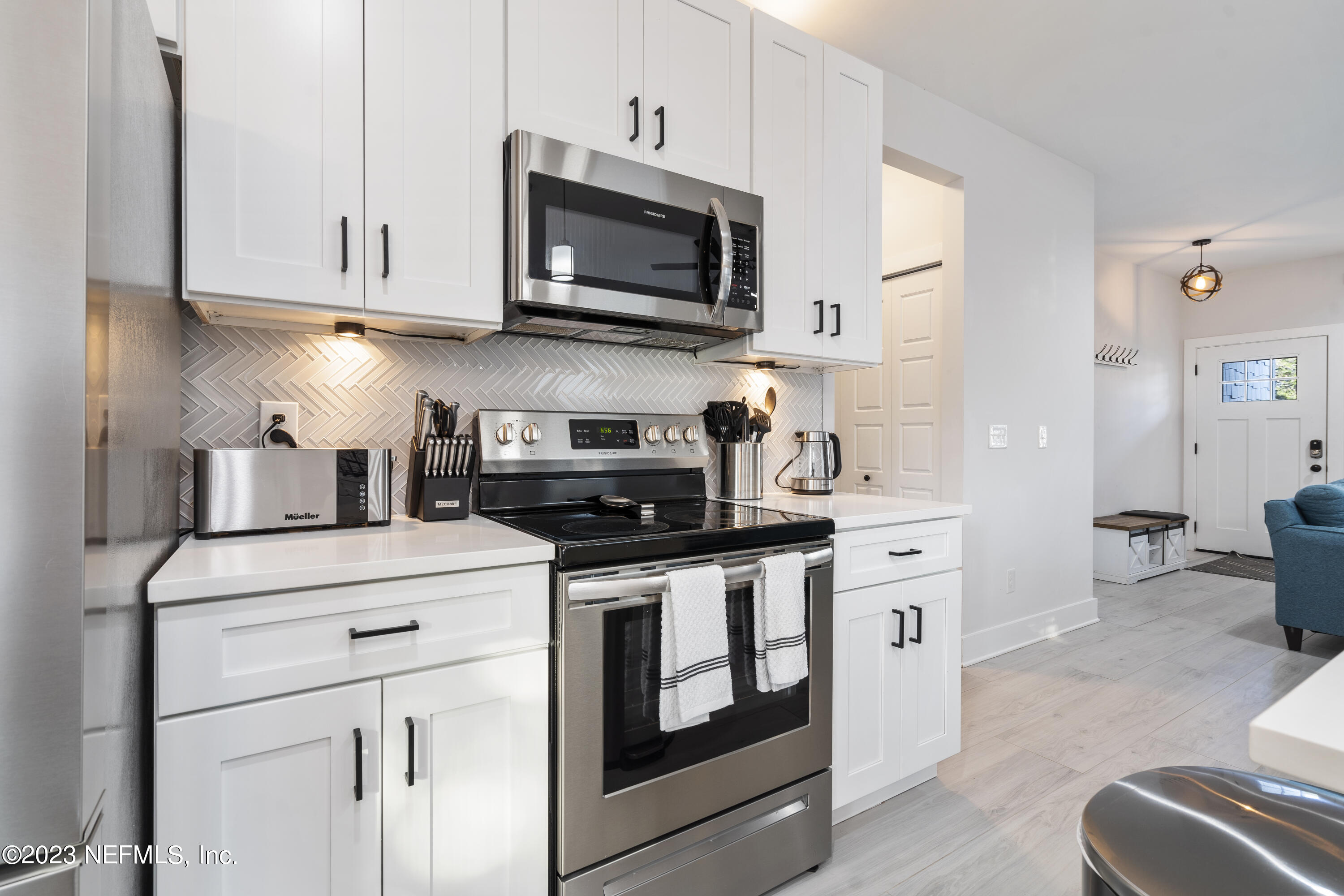 310 3rd Street St. Augustine, FL 32084 - Photo 14 of 46 a kitchen with stainless steel appliances granite countertop a stove and a microwave
