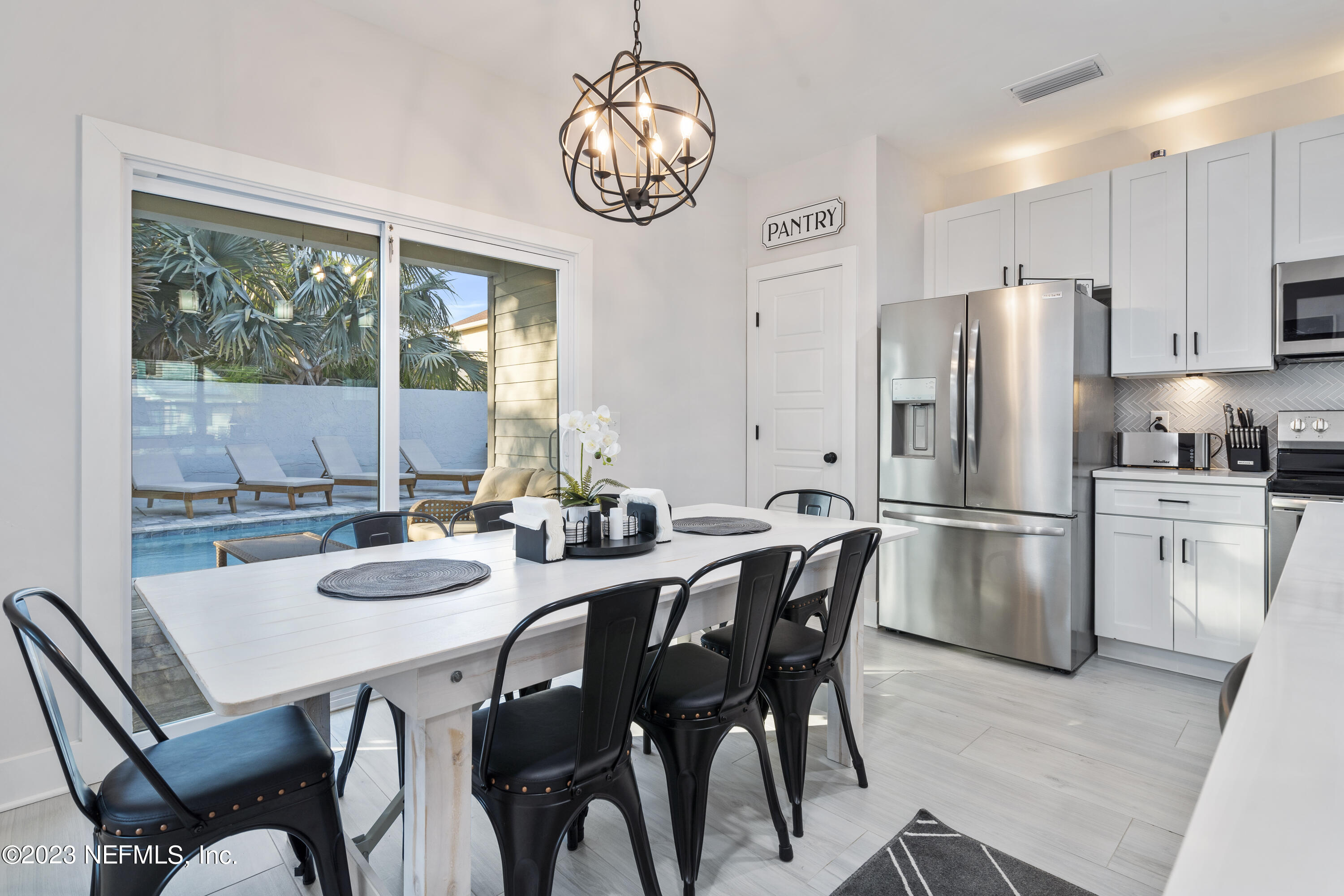 310 3rd Street St. Augustine, FL 32084 - Photo 15 of 46 a kitchen with stainless steel appliances granite countertop a dining table and chairs