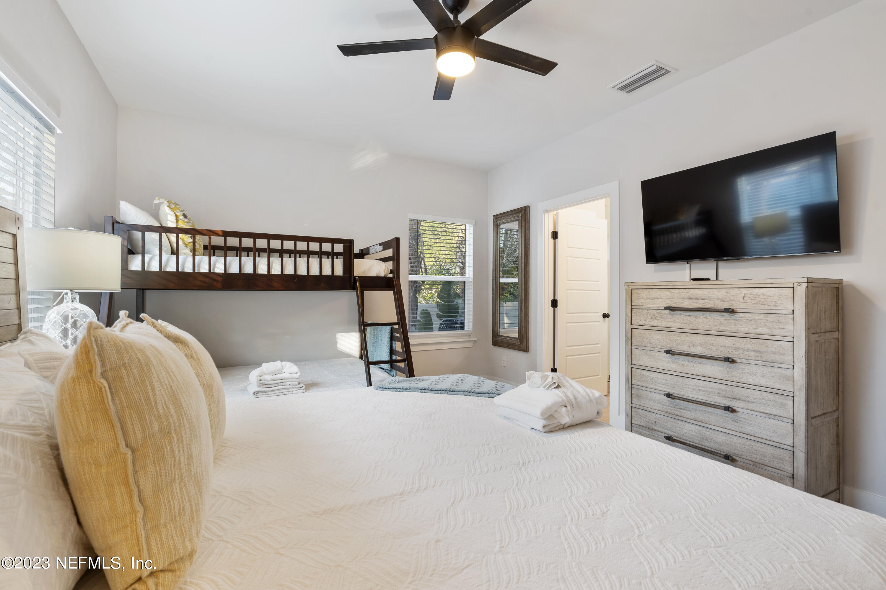 310 3rd Street St. Augustine, FL 32084 - Photo 18 of 46 a bedroom with a bed and a flat screen tv