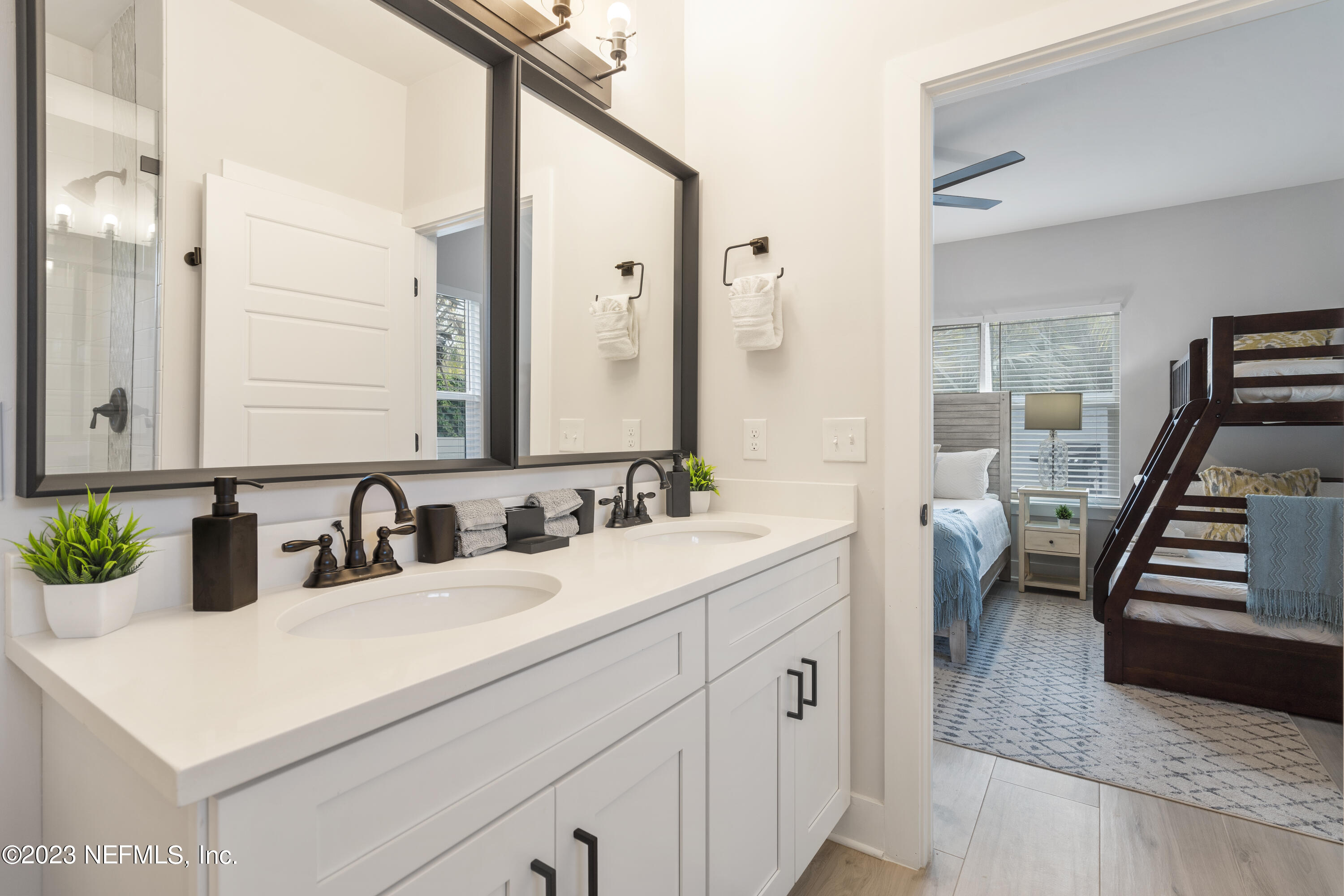 310 3rd Street St. Augustine, FL 32084 - Photo 19 of 46 a bathroom with a sink and a mirror