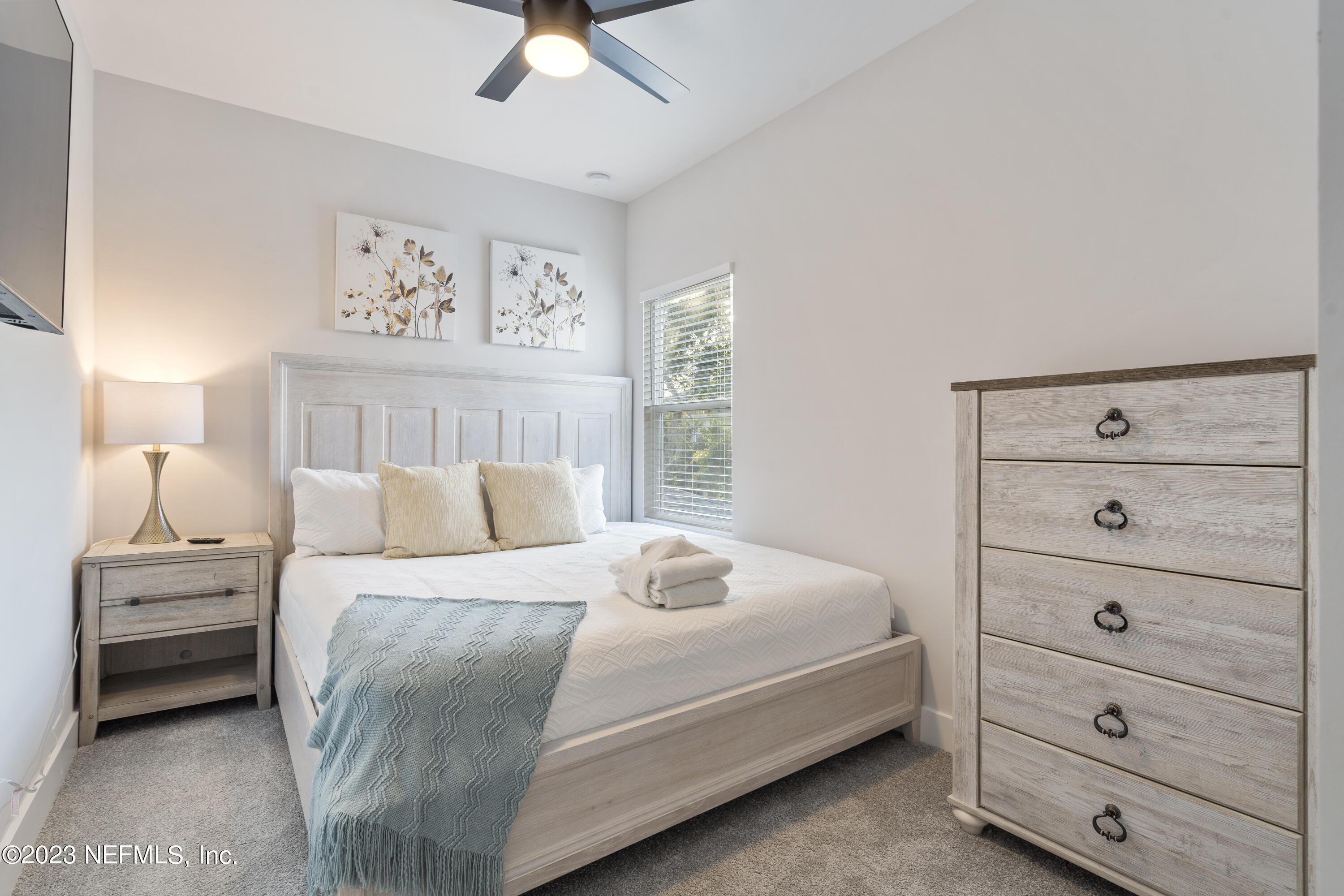 310 3rd Street St. Augustine, FL 32084 - Photo 24 of 46 a bedroom with a bed and a window