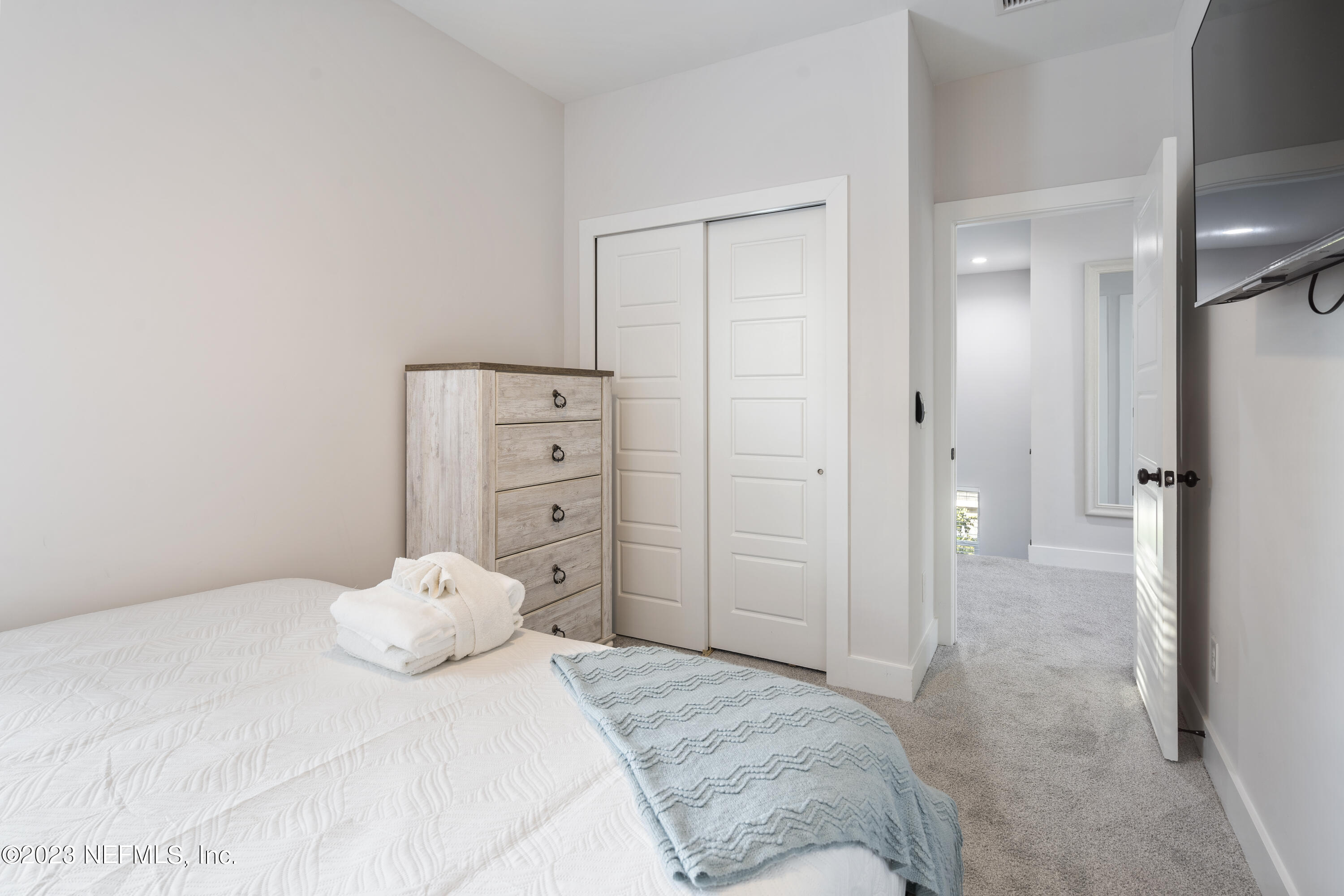 310 3rd Street St. Augustine, FL 32084 - Photo 25 of 46 a bedroom with a bed and a walk in closet