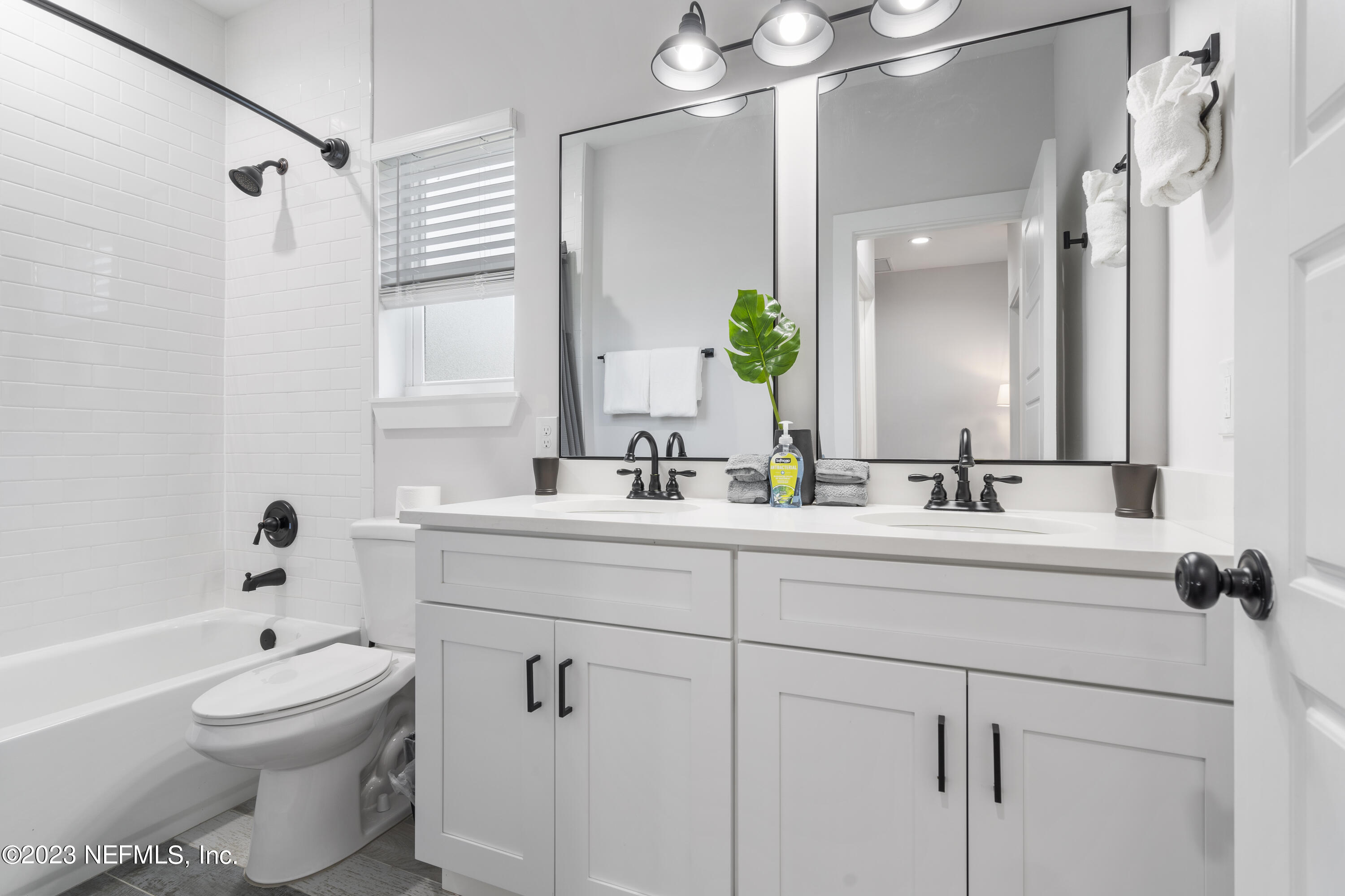 310 3rd Street St. Augustine, FL 32084 - Photo 26 of 46 a bathroom with a sink a toilet and a mirror