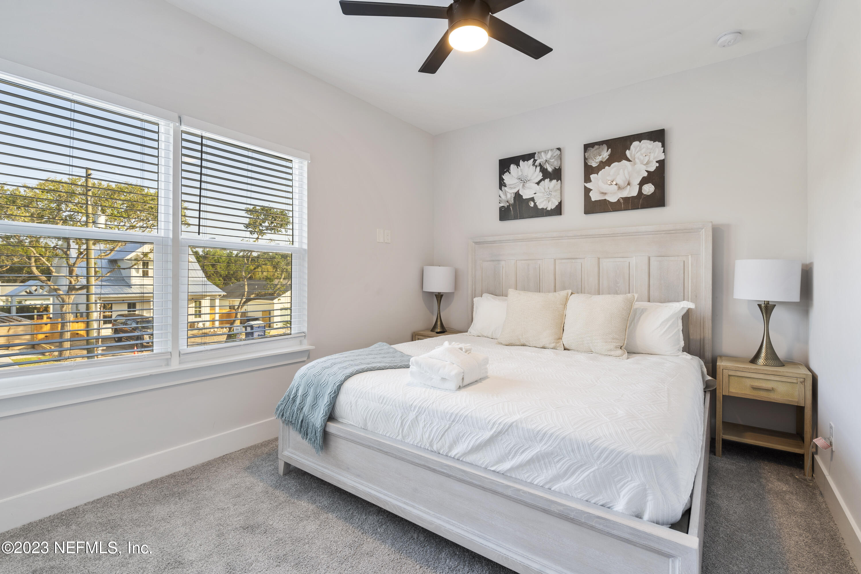 310 3rd Street St. Augustine, FL 32084 - Photo 27 of 46 a bedroom with a large bed and a large window