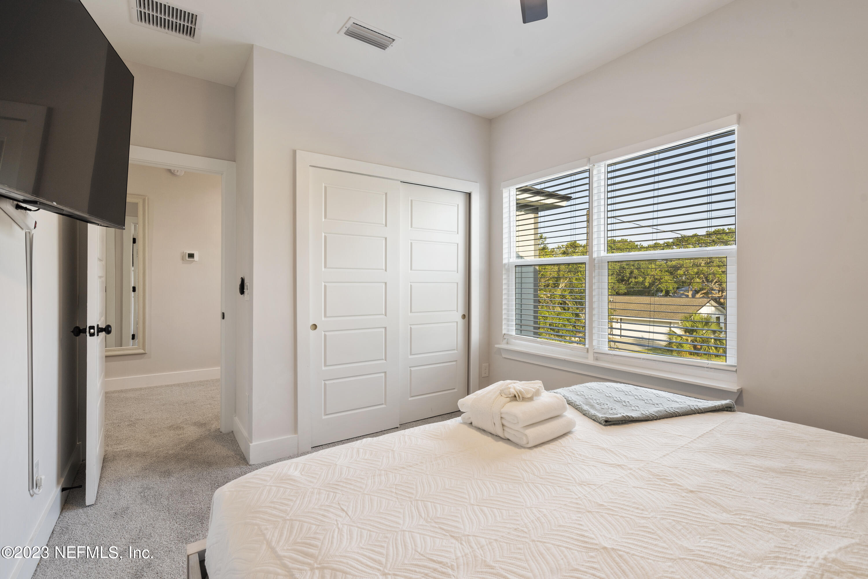 310 3rd Street St. Augustine, FL 32084 - Photo 28 of 46 a bedroom with a bed and a large window