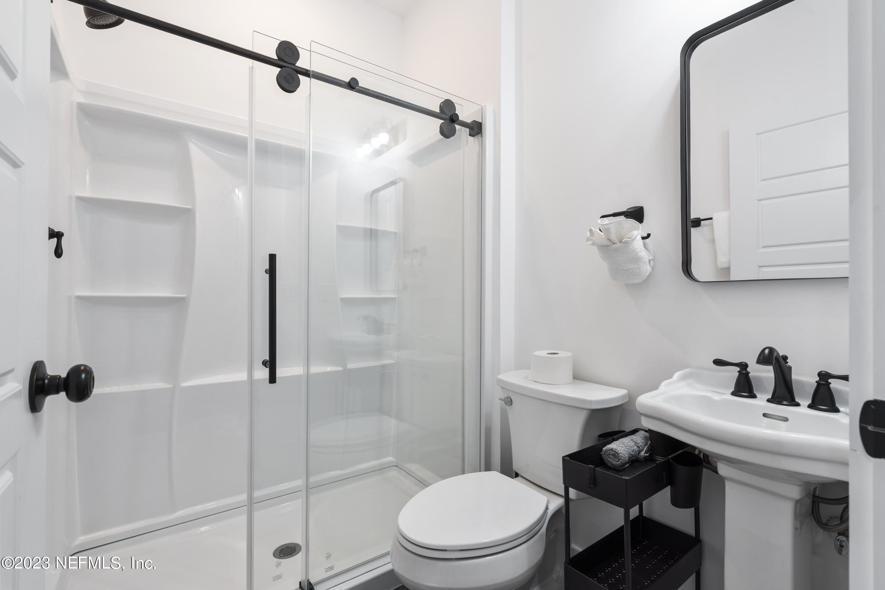 310 3rd Street St. Augustine, FL 32084 - Photo 29 of 46 a bathroom with a sink toilet and shower