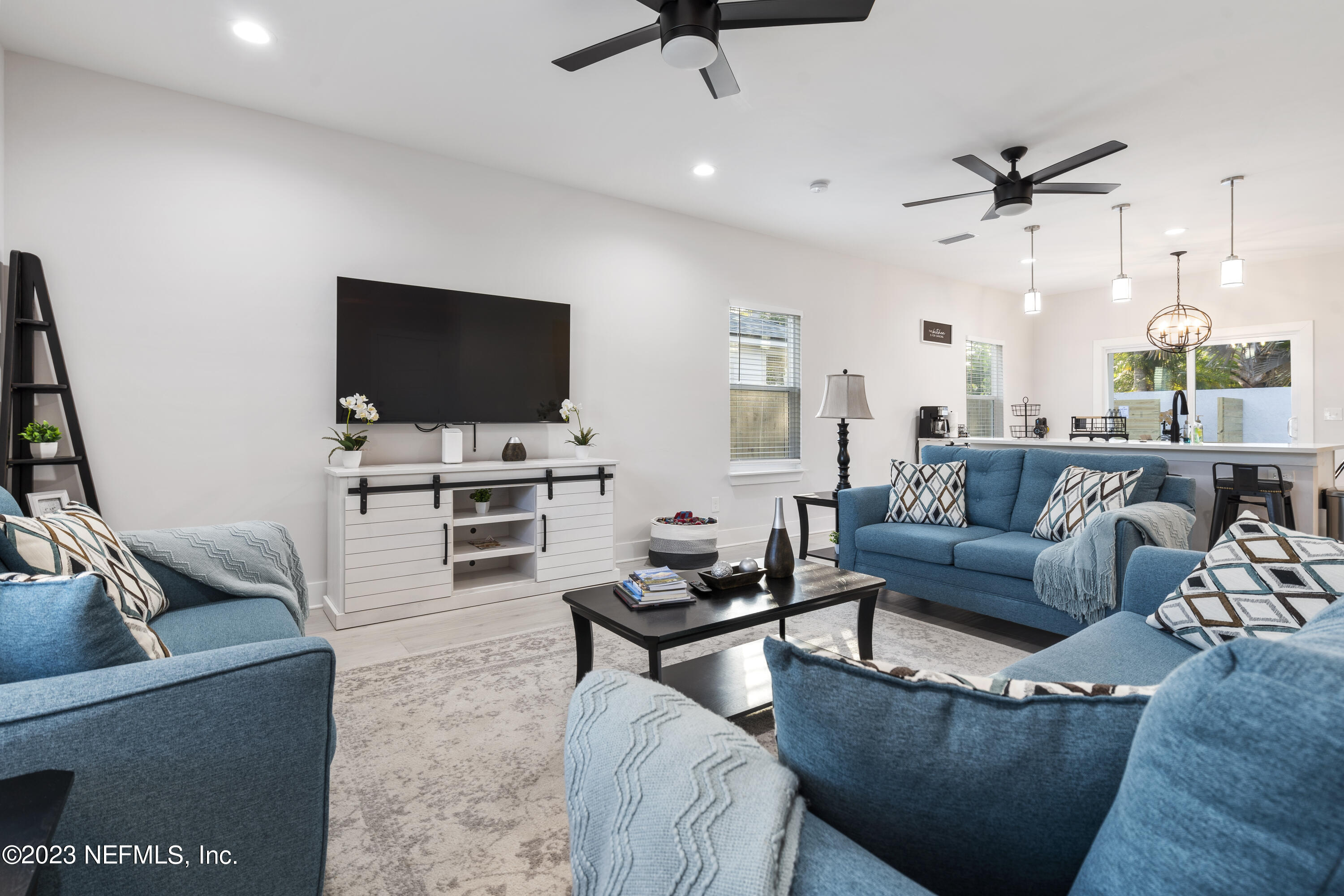 310 3rd Street St. Augustine, FL 32084 - Photo 3 of 46 a living room with furniture and a flat screen tv