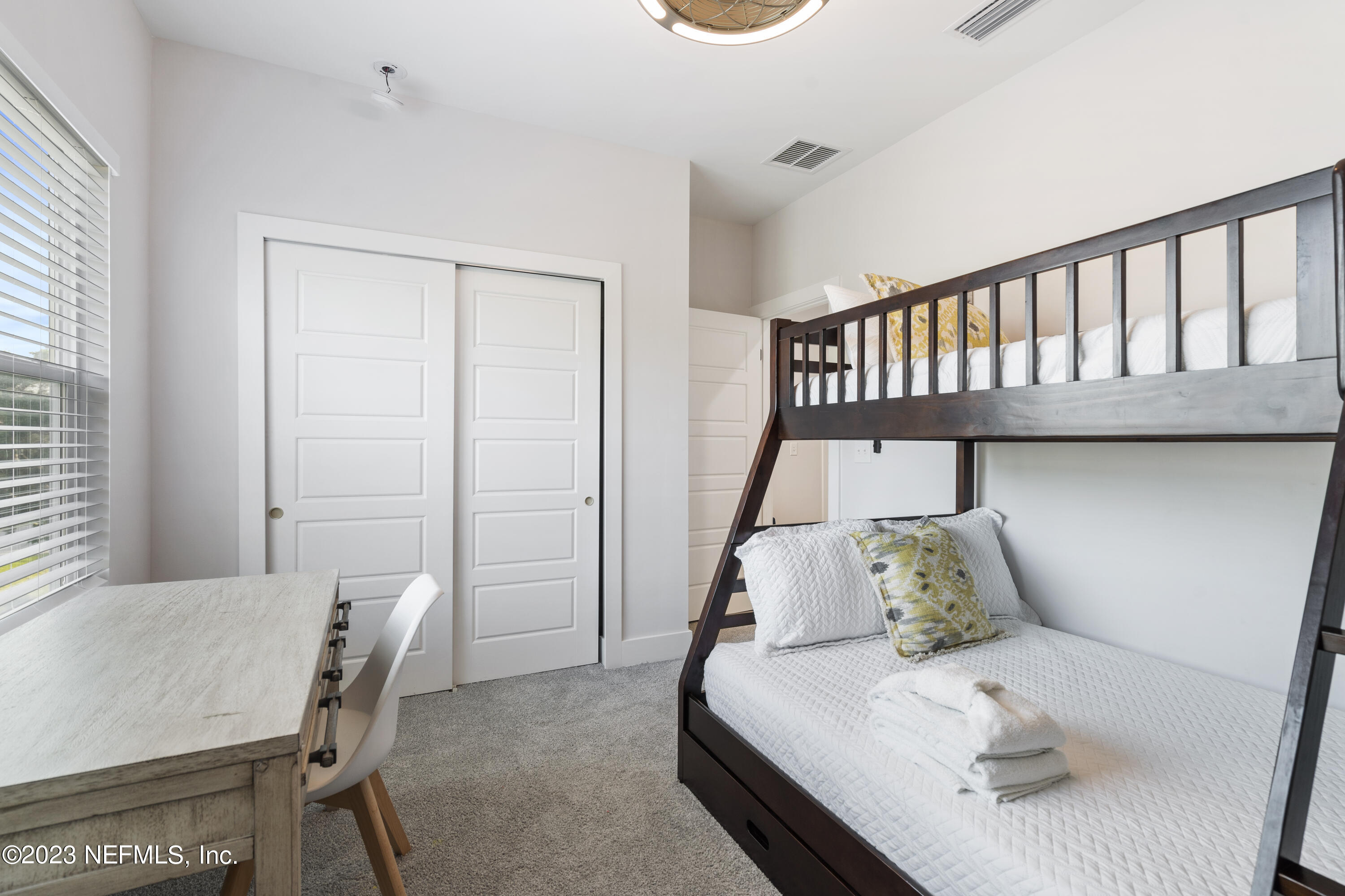 310 3rd Street St. Augustine, FL 32084 - Photo 31 of 46 a bedroom with a bed and a table