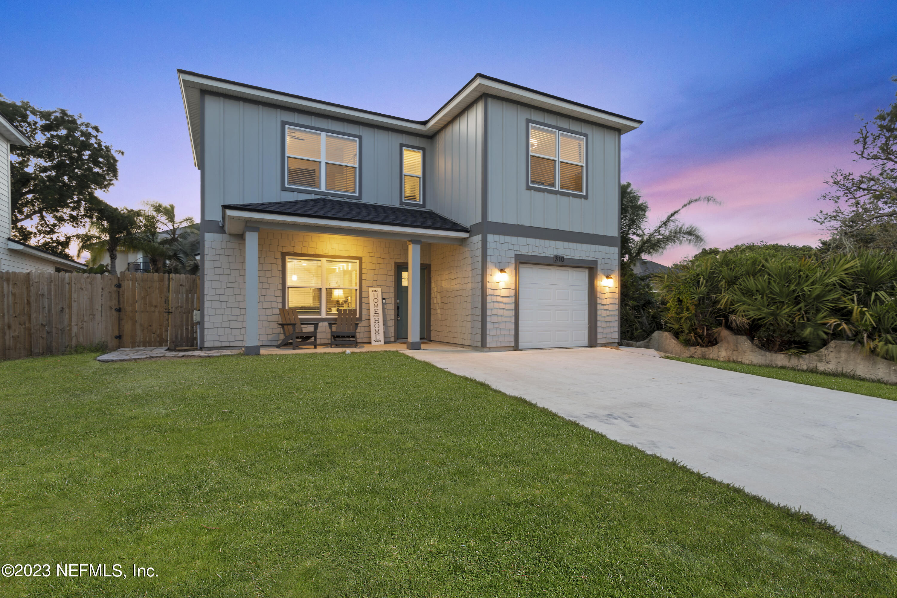 310 3rd Street St. Augustine, FL 32084 - Photo 6 of 46 a front view of a house with a yard and garage
