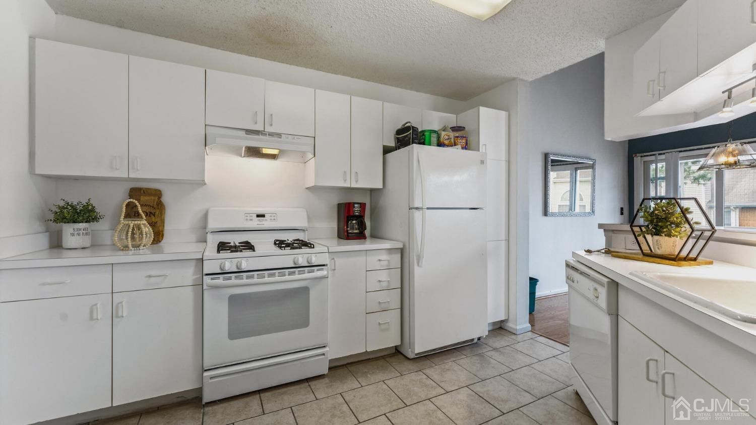 835 Edpas Road New Brunswick, NJ 08901 - Photo 5 of 15 a kitchen with white cabinets and white appliances