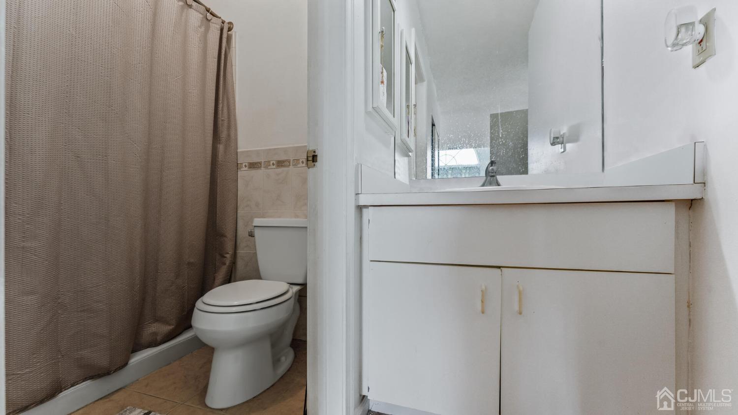 835 Edpas Road New Brunswick, NJ 08901 - Photo 9 of 15 a bathroom with a toilet and a mirror