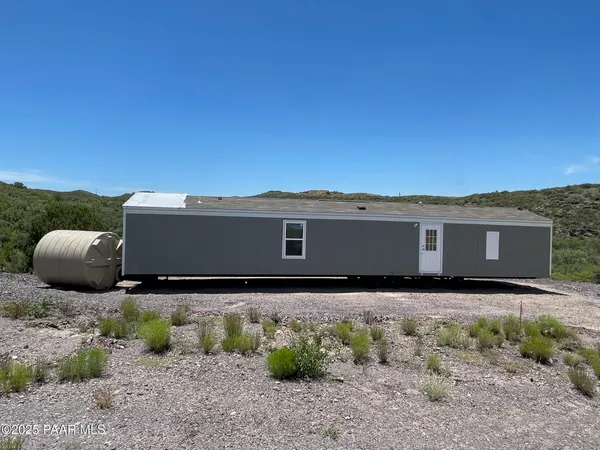 a view of house with a yard