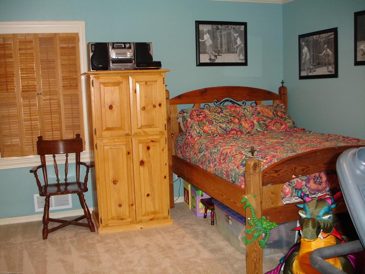 6315 Elmhurst Road Amarillo, TX 79106 - Photo 5 of 9 a bed sitting in a bedroom next to a window
