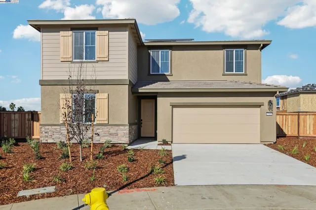 a front view of a house with parking area