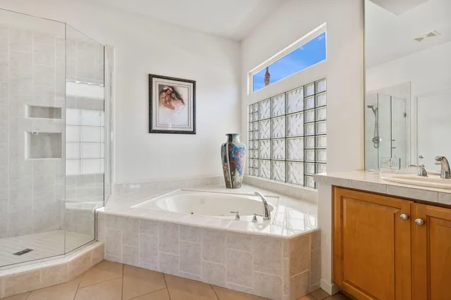 a bedroom with a bed and a dresser next to a window