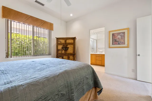 a bathroom with a double vanity sink a toilet and a mirror