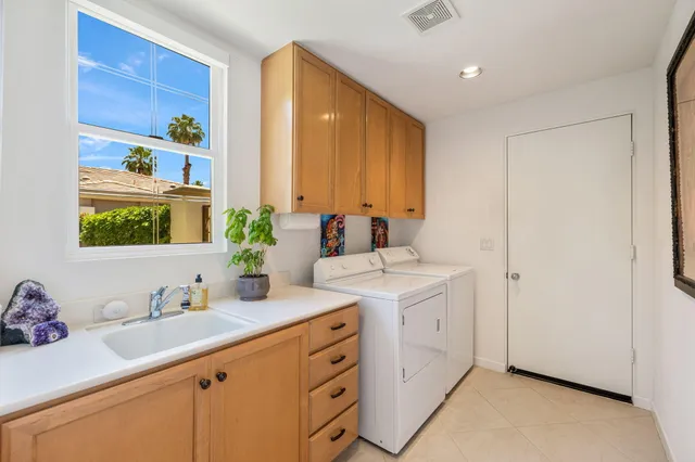a front view of a house with garden and patio