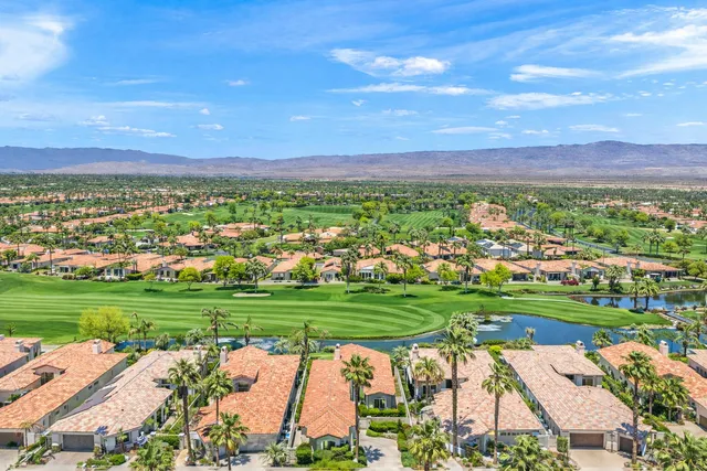 a view of a lake with houses in the back
