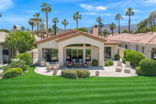 a backyard of a house with outdoor seating