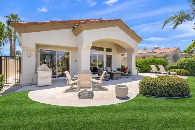 a view of a chairs and table in the garden