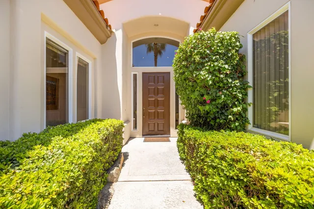 a hallway with a couch and paintings on the wall
