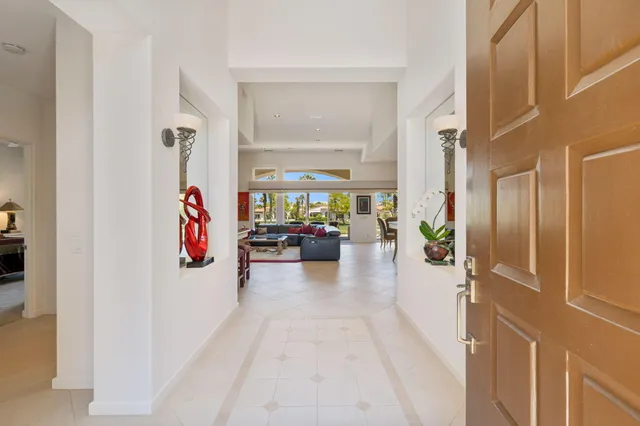 a kitchen with stainless steel appliances granite countertop a refrigerator and a dining table