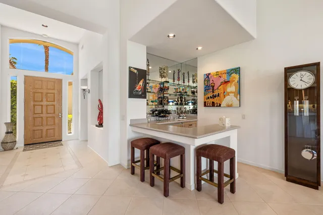 a living room with lots of furniture and kitchen view