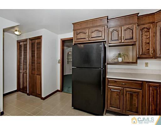 348 Ridge Road Dayton, NJ 08810 - Photo 11 of 21 a kitchen with stainless steel appliances granite countertop a refrigerator a stove and a cabinet