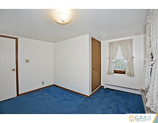 348 Ridge Road Dayton, NJ 08810 - Photo 14 of 21 a view of an empty room with wooden floor and a window