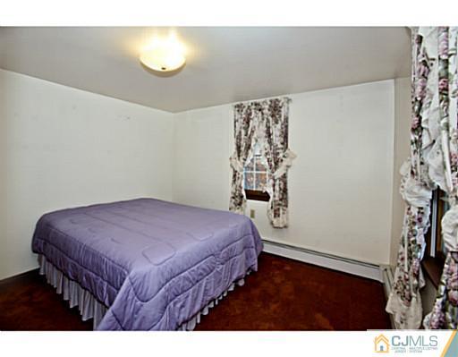 348 Ridge Road Dayton, NJ 08810 - Photo 15 of 21 a bedroom with a bed and a table
