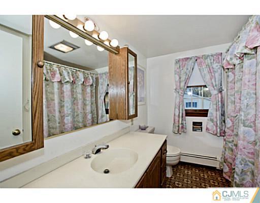 348 Ridge Road Dayton, NJ 08810 - Photo 16 of 21 a bathroom with a bathtub a shower and a sink