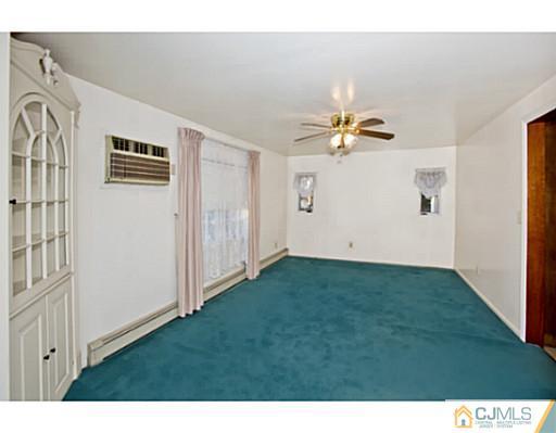 348 Ridge Road Dayton, NJ 08810 - Photo 6 of 21 a view of an empty room with a ceiling fan