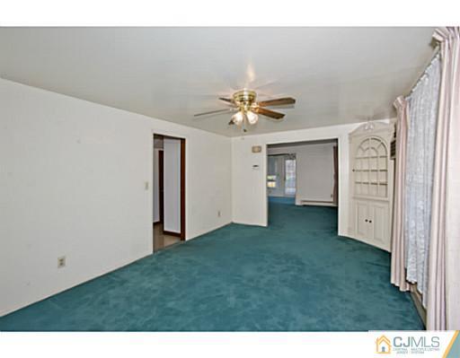 348 Ridge Road Dayton, NJ 08810 - Photo 7 of 21 a view of an empty room with a ceiling fan