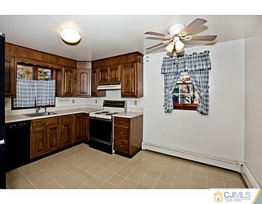 348 Ridge Road Dayton, NJ 08810 - Photo 8 of 21 a kitchen with a refrigerator a sink and a stove