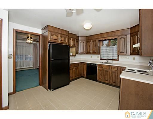 348 Ridge Road Dayton, NJ 08810 - Photo 10 of 21 a kitchen with a refrigerator and a sink
