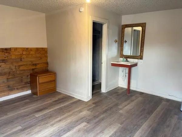 wooden floor in a hall with a window