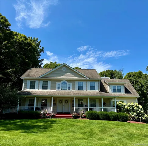 a front view of a house with garden and swimming pool