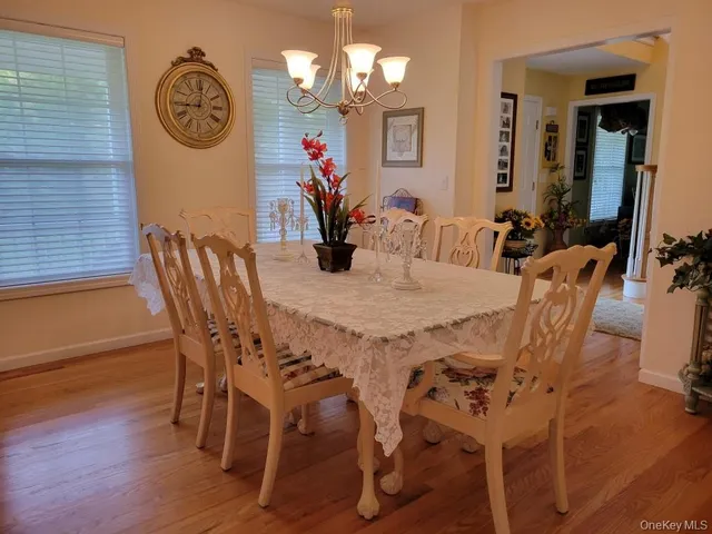 a view of a dining room with furniture and a chandelier